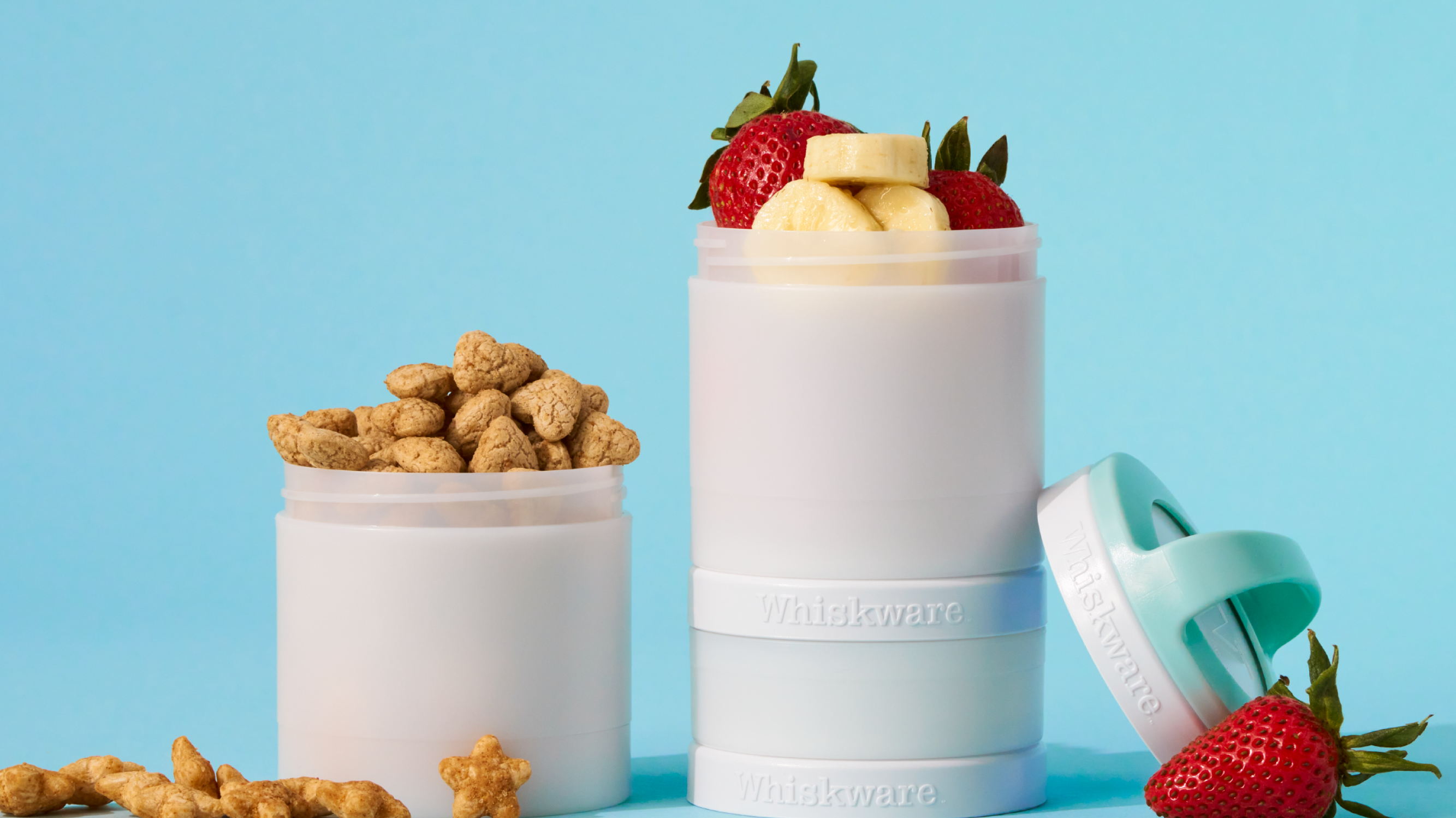 Whiskware Snack Containers with fruits & snacks.