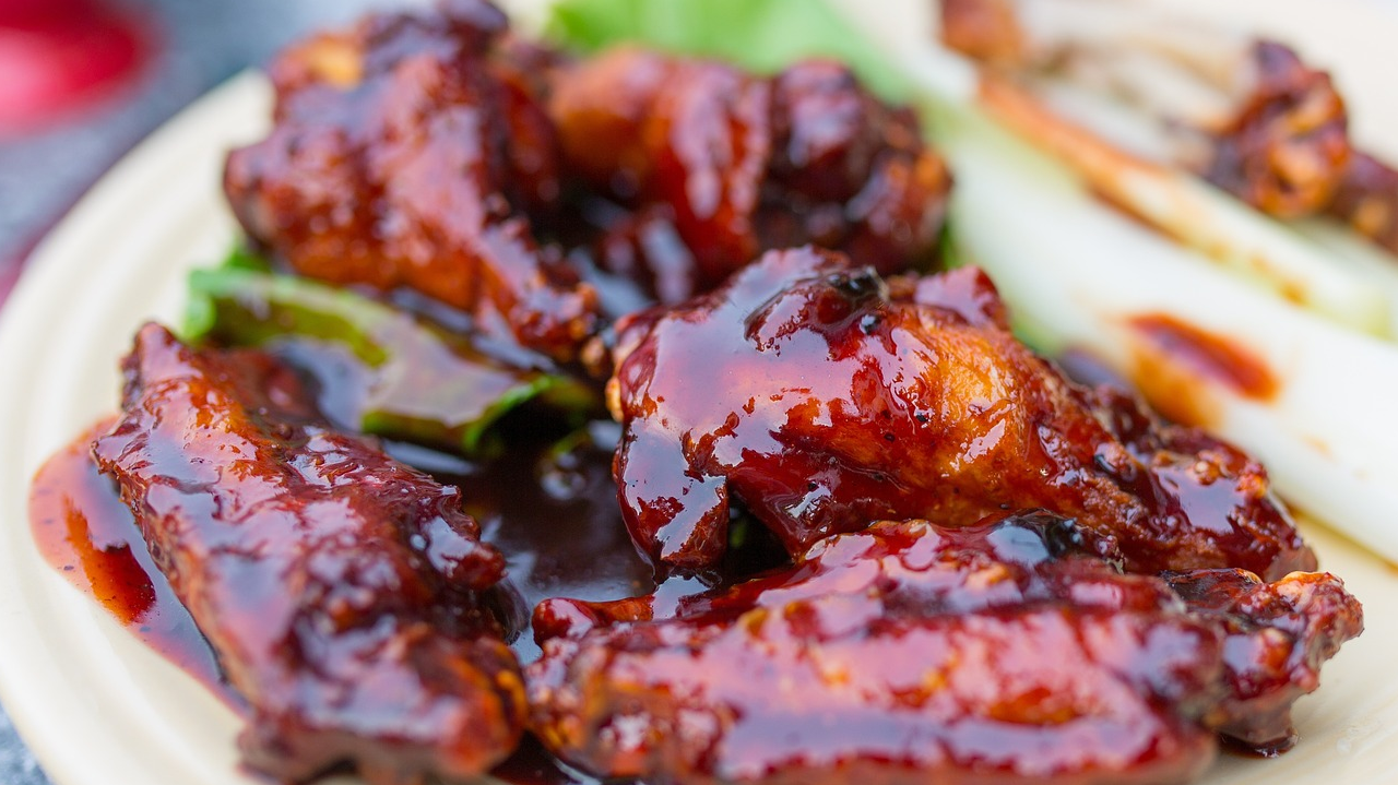a stack of chicken wings coated in fat free honey bbq sauce