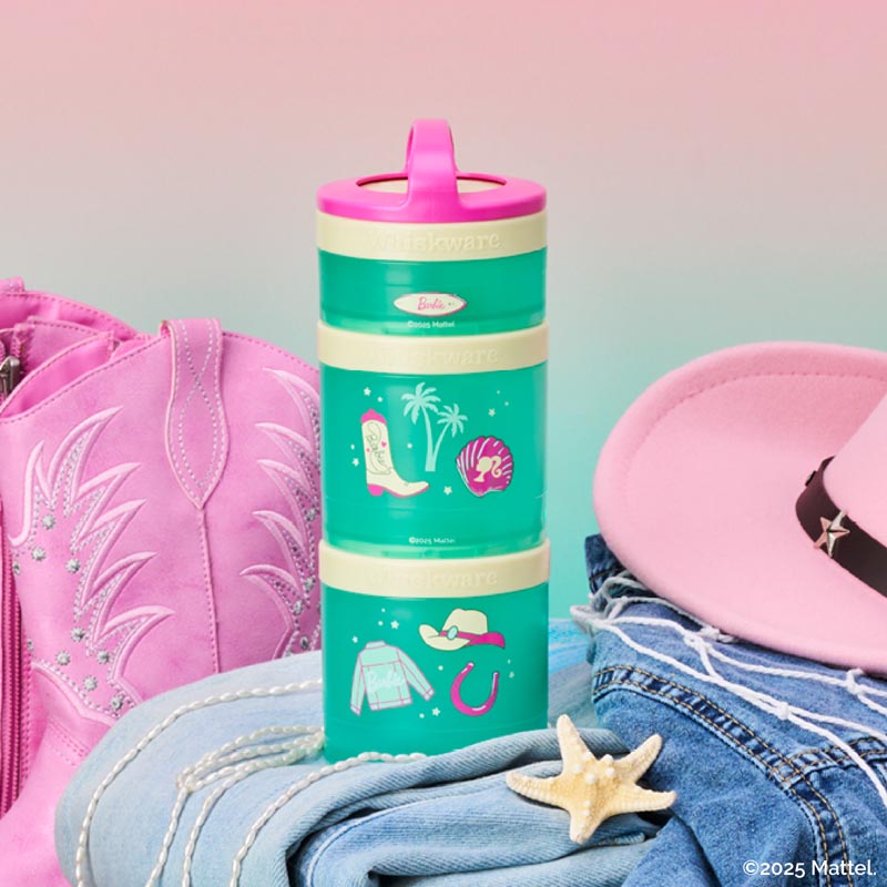 Green snack containers with pink carry handle and cowgirl-themed design, surrounded by pink cowboy boots and hat on a gradient background.