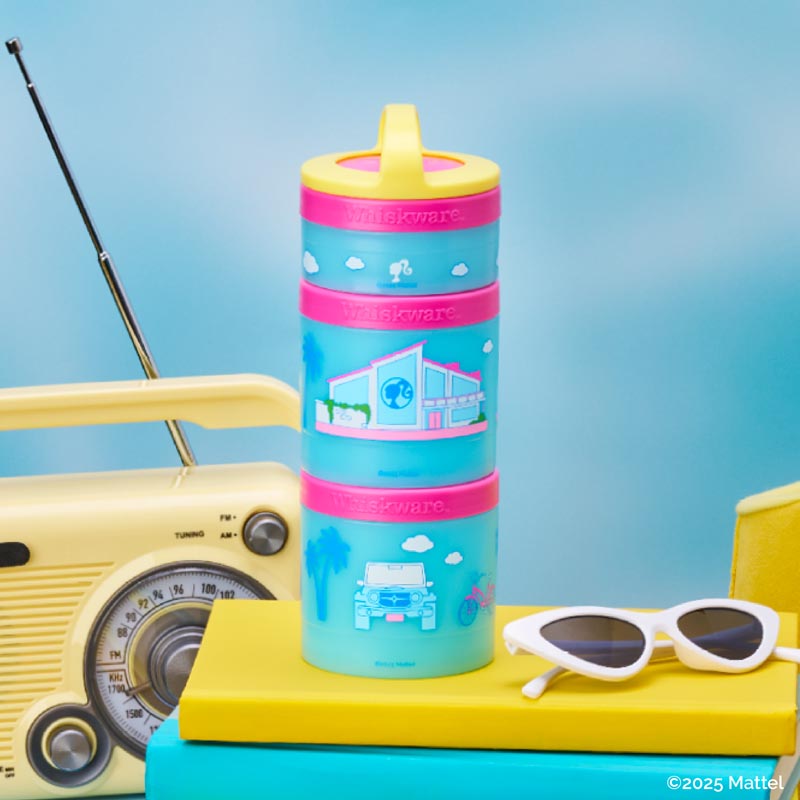 Stackable Barbie snack container with pink lids and blue cups on a blue background, featuring a vintage radio and sunglasses.