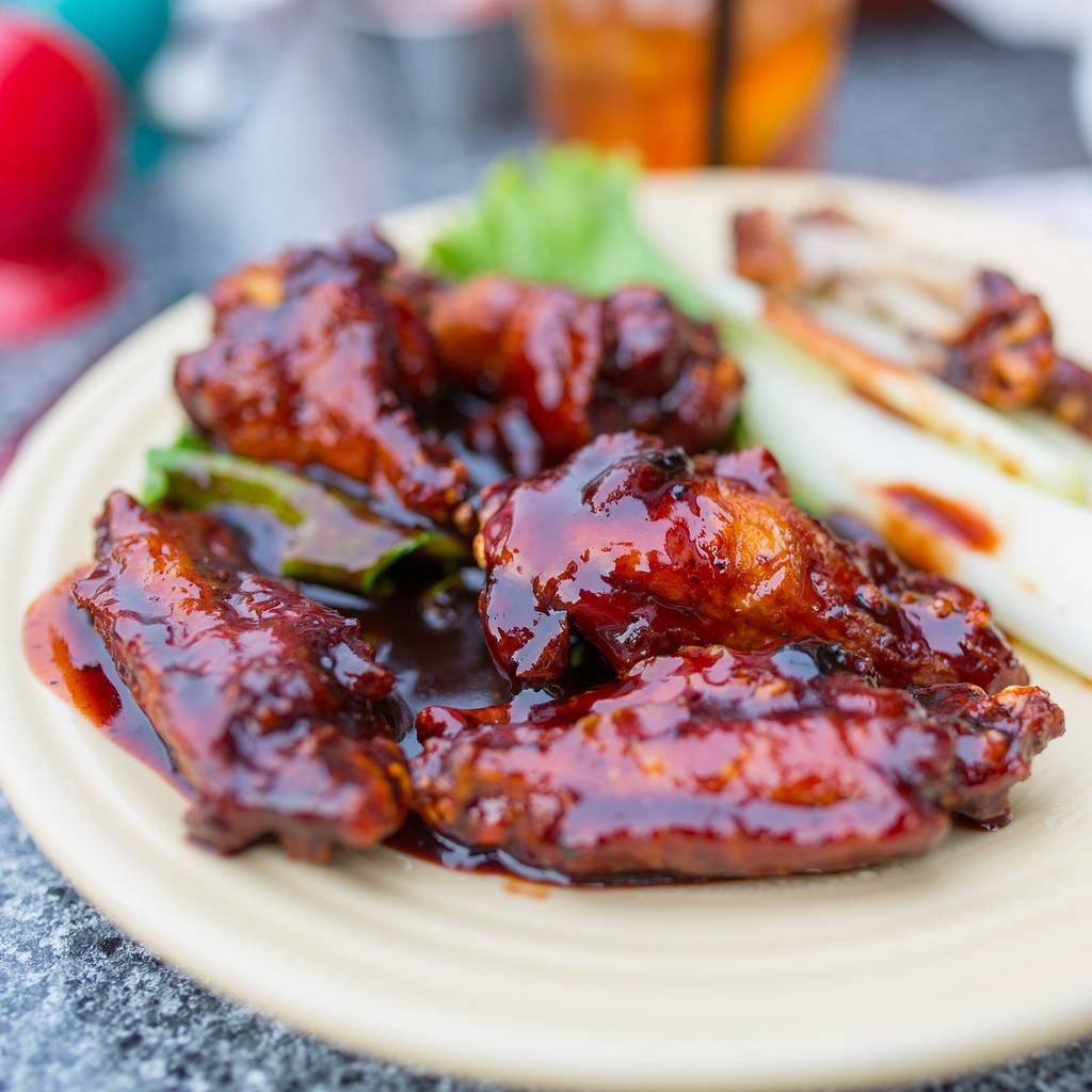 a stack of chicken wings coated in fat free honey bbq sauce