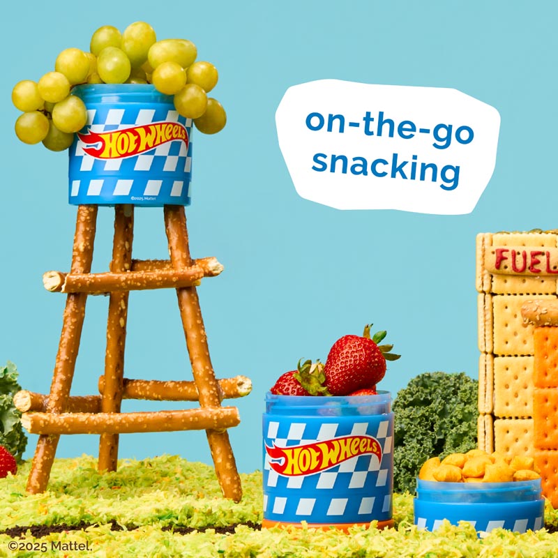 Hot Wheels snack containers with fruits and snacks on a blue background featuring the text 'on-the-go snacking'