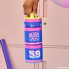Stack of Barbie-themed snack containers with a hand holding the top handle against a pink background.