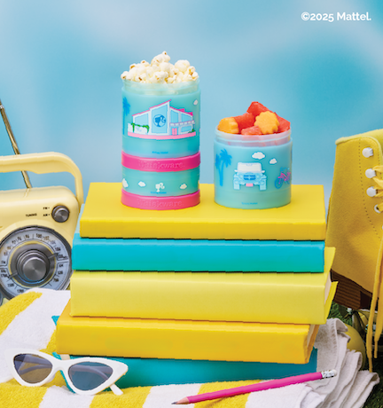 Colorful snack containers on a stack of blue and yellow books with a blue background.